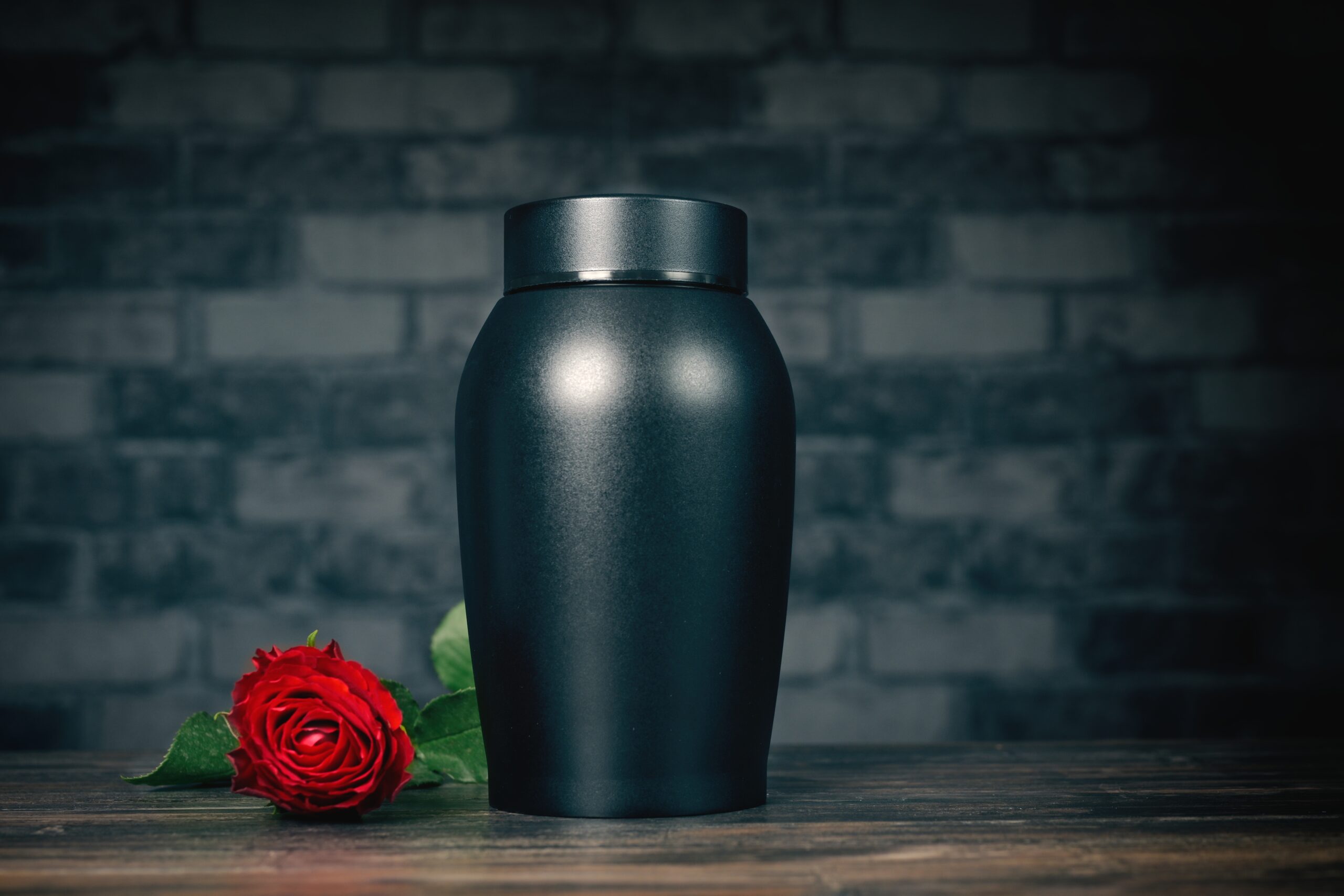 Funeral mourning urn next to a rose